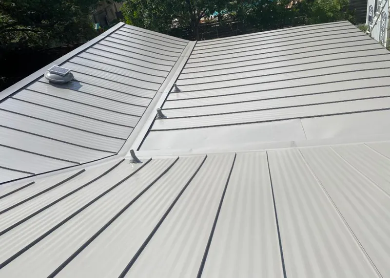 Solar attic fan installed on a metal roof for Roof Ventilation in Huntertown